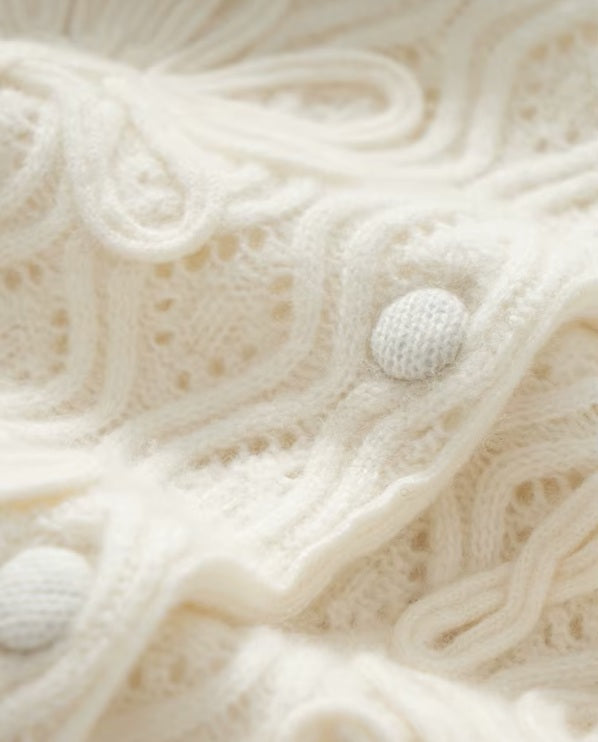 The fabric-covered buttons on the women's Embossed Lace Cashmere Cardigan in Pearl Bush, adding a refined and cohesive detail, Borcelleclothes.