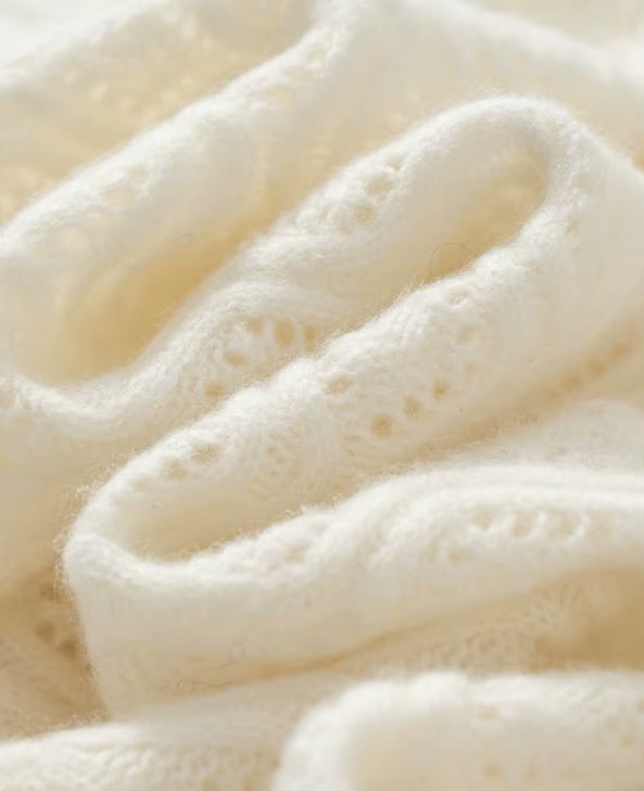 The serpentine folds on the women's Embossed Lace Cashmere Cardigan in Pearl Bush, highlighting the flowing and elegant texture, Borcelleclothes.