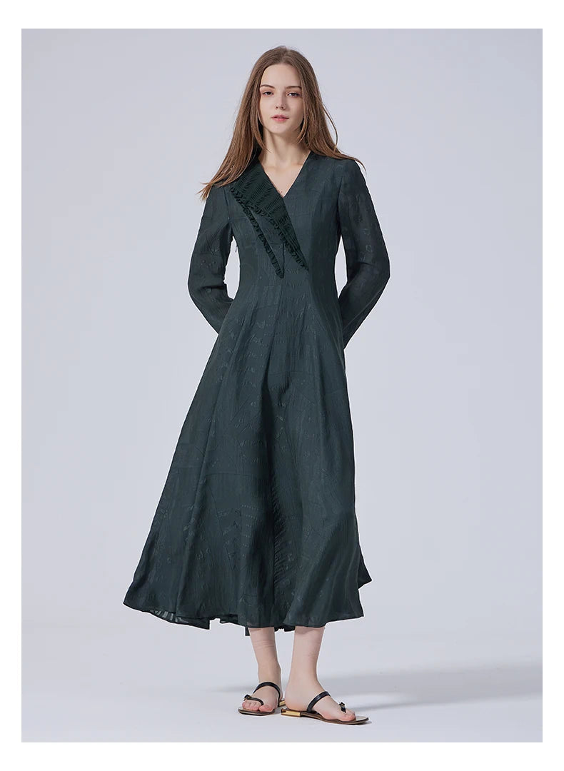 Model posing with hand behind back in the embroidered silk dress. From Borcelleclothes.