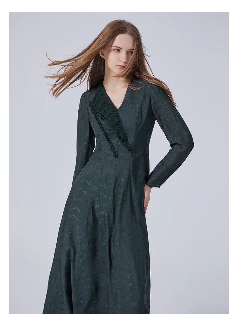 Model wearing the embroidered jacquard silk dress in Outer Space, hand resting on hip. From Borcelleclothes.