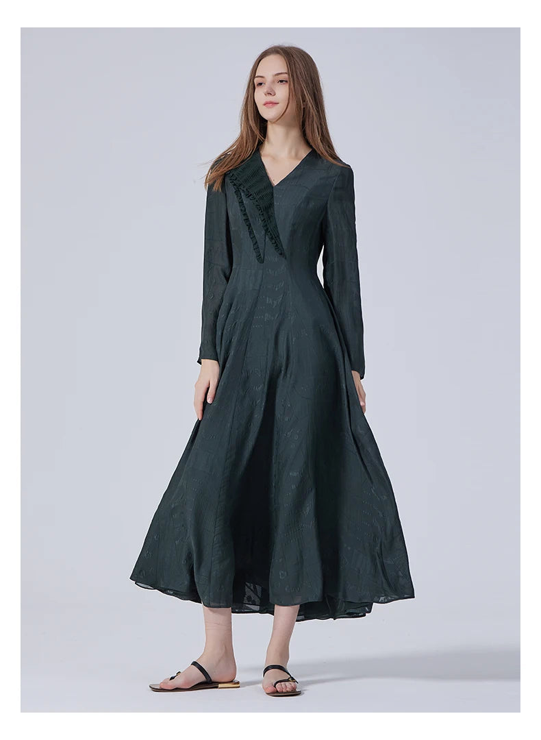 Model looking sideways while wearing the embroidered silk dress. From Borcelleclothes.