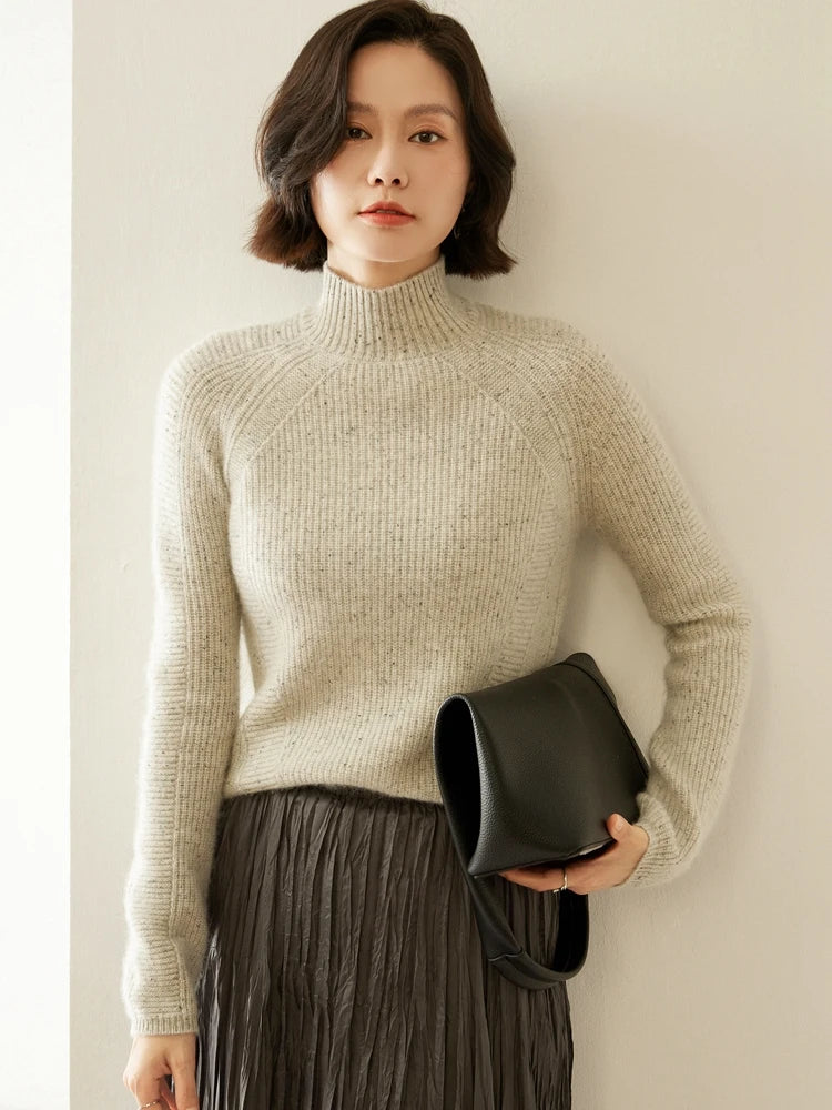 Model wearing Fern Breeze cashmere sweater, holding a bag; angled purl stripes and melange color clearly visible — From Borcelleclothes.