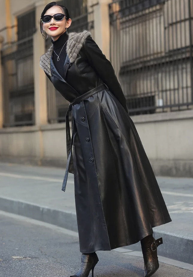 Women's Flared Hooded Coat in Onyx. Model slightly bends forward, displaying the coat’s structured yet fluid movement. Borcelleclothes.