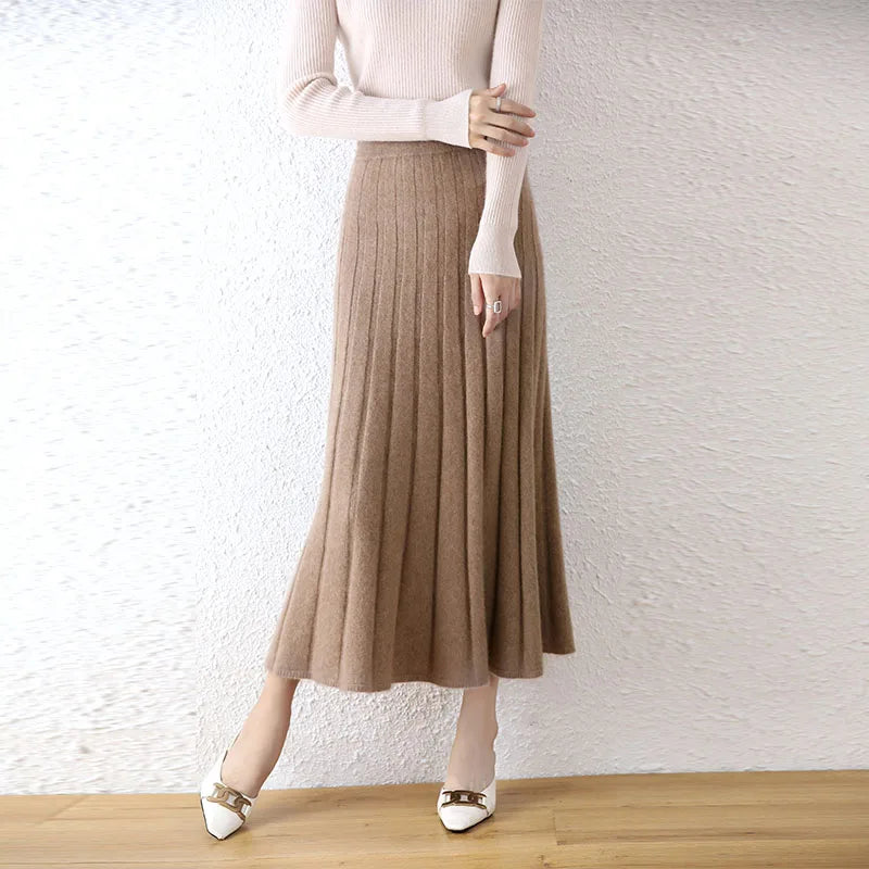 Women's flared pleat wool skirt in Pastel Brown, model resting hand on arm — From Borcelleclothes.