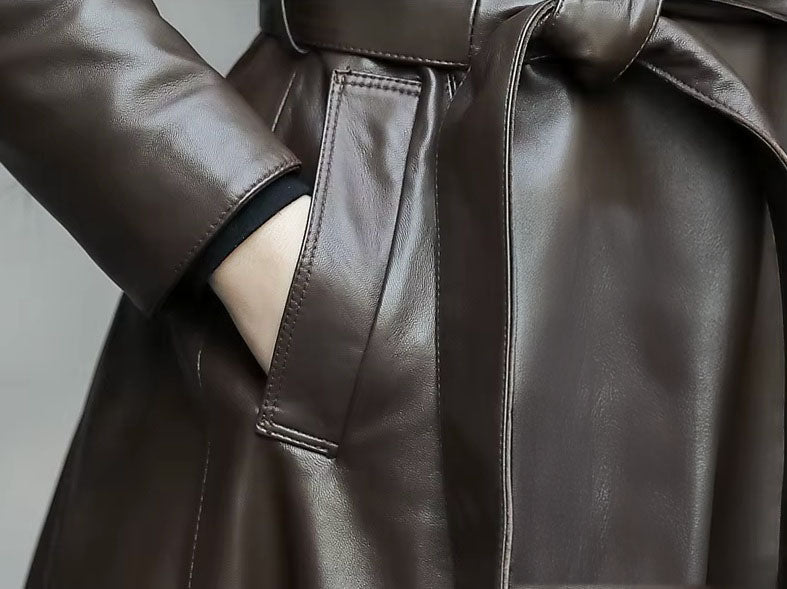 Women's Flowing Leather Coat in Taupe. Model rests hand in the pocket, emphasizing the seamless integration of function and tailored precision. Borcelleclothes.