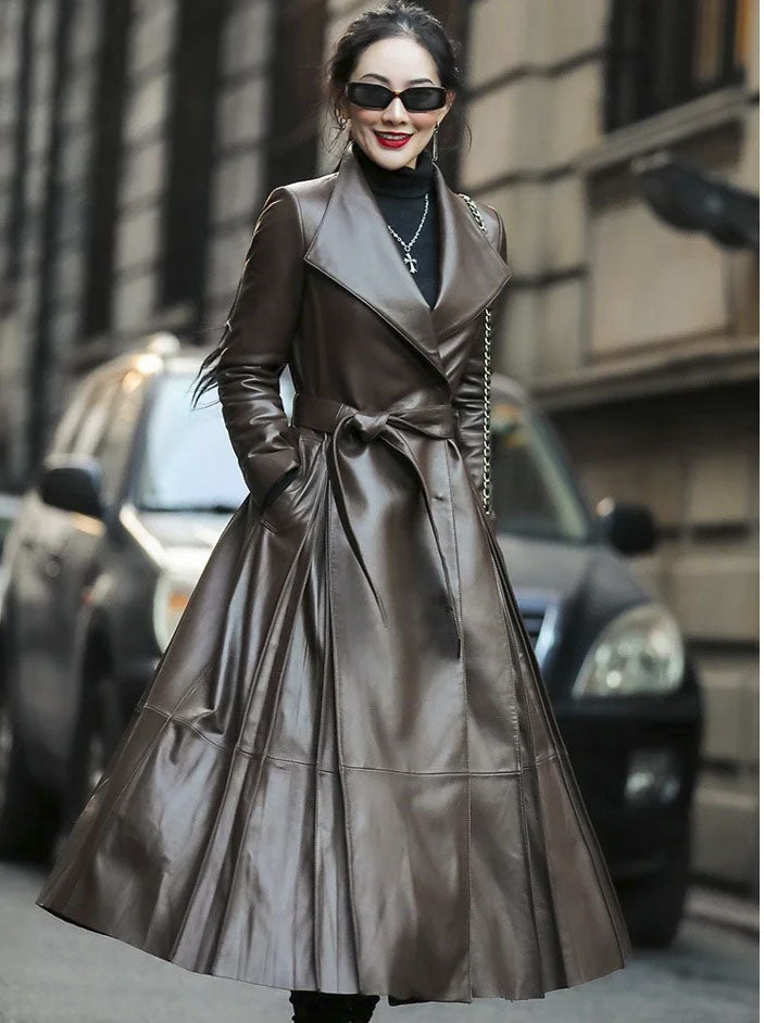 Women's Flowing Leather Coat in Taupe. Model twirls, highlighting the coat’s breathtaking volume and dynamic leather drape. Borcelleclothes.