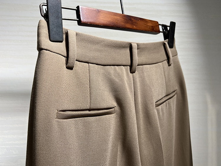 Back upper part of Almond Frost trousers, highlighting waistband and tailored structure. From Borcelleclothes.