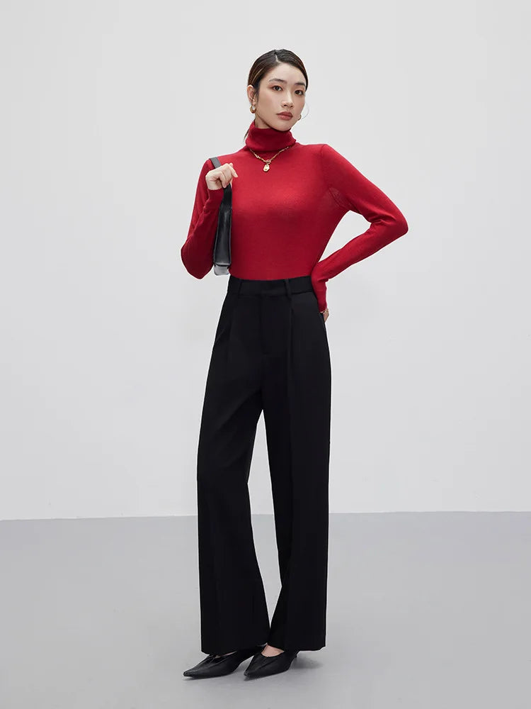 Woman rests hand on waistband of Onyx trousers, drawing attention to the tailored waist detail. From Borcelleclothes.