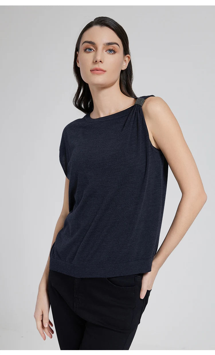 Model wearing the Black Pearl top with one hand in pants pocket, showing the relaxed, asymmetrical silhouette. From Borcelleclothes.