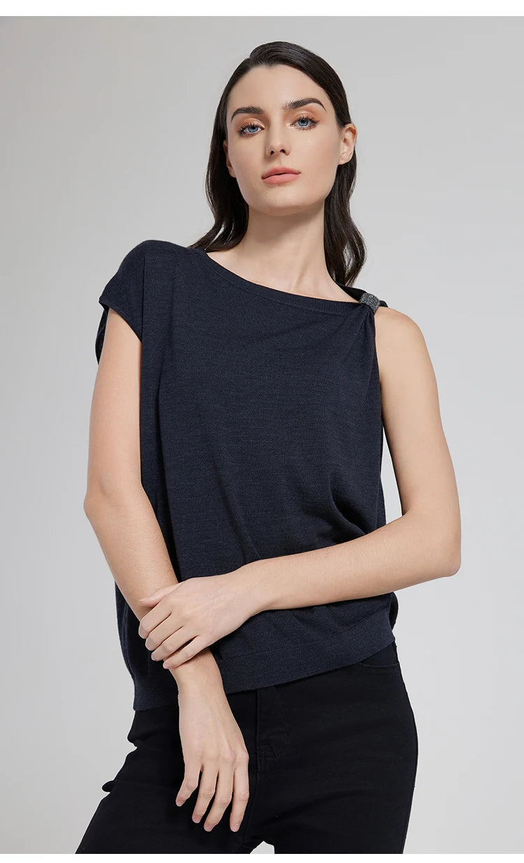 Black Pearl top styled with the model holding her wrist, highlighting the shimmering fringe detail. From Borcelleclothes.