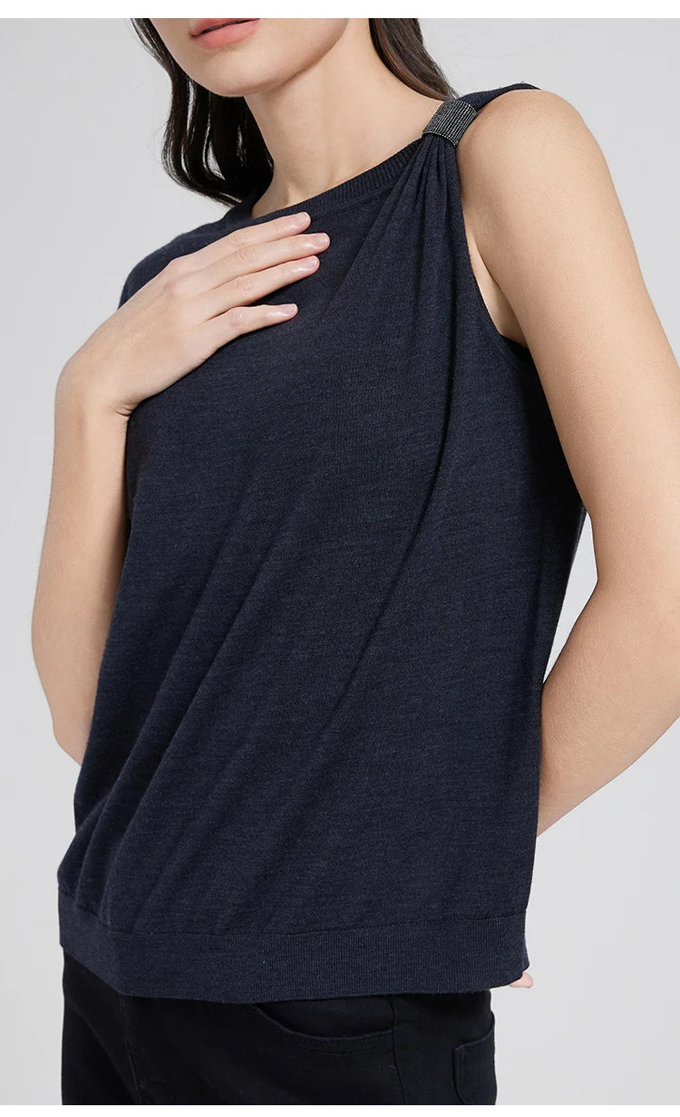 Model in Black Pearl top lightly touching her chest, emphasizing the gathered shoulder and soft drape. From Borcelleclothes.