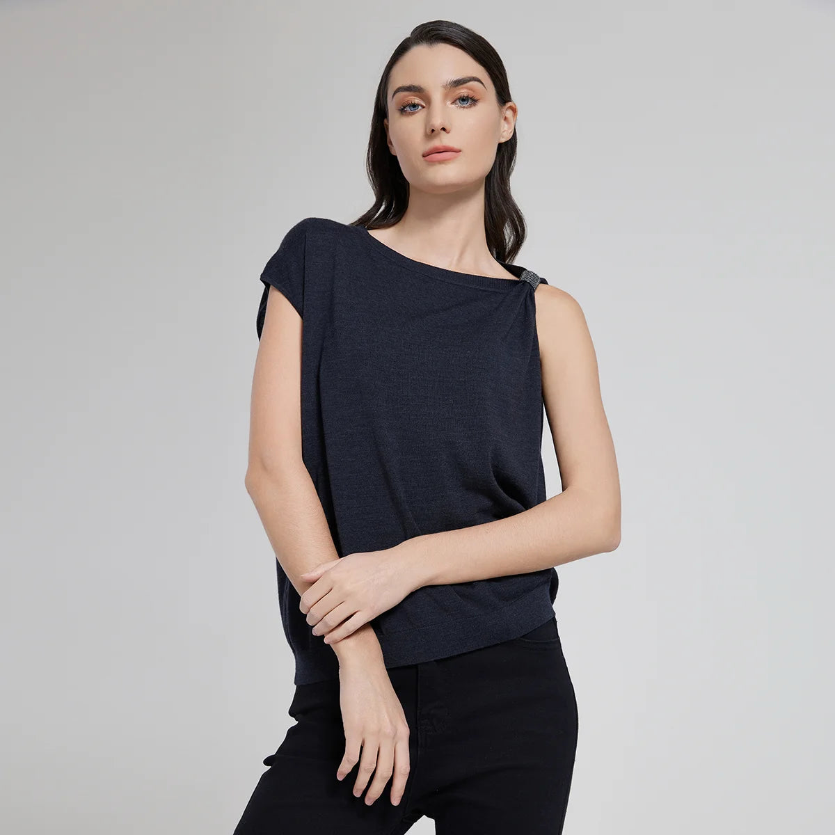 Women's top in Black Pearl color with gathered left shoulder, shimmering fringe, and soft merino wool–silk texture. From Borcelleclothes.