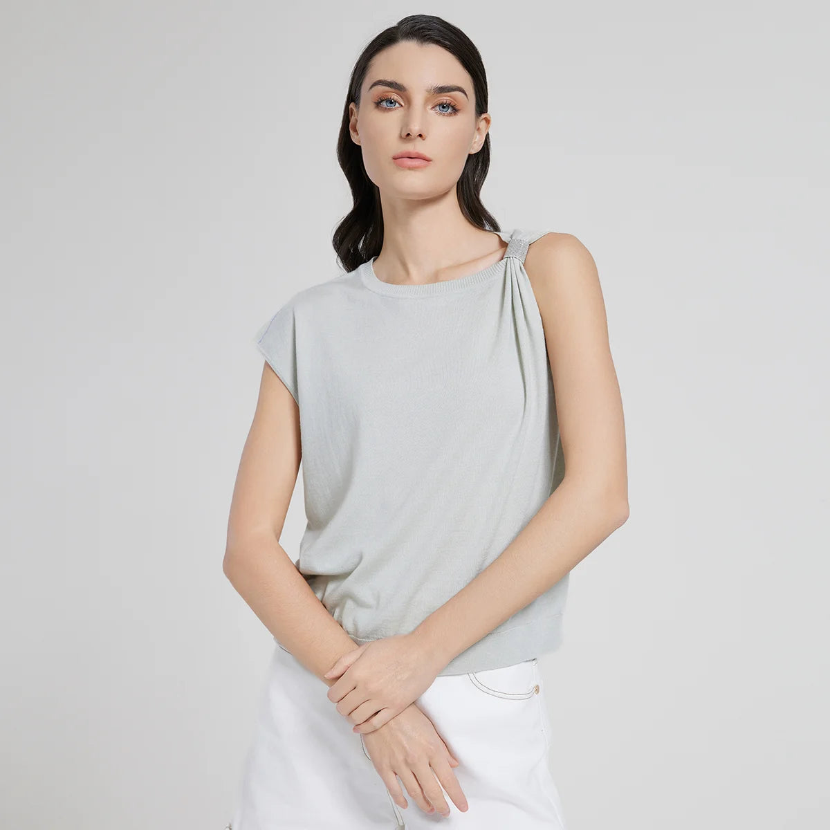 Women's top in Geyser color with gathered left shoulder, shimmering fringe, and soft merino wool–silk texture. From Borcelleclothes.