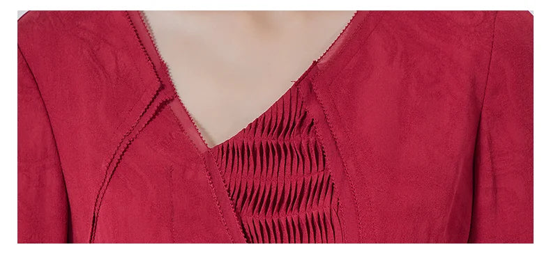 Detailed shot of the asymmetrical V-neckline where georgette softly emerges from beneath the jacquard. From Borcelleclothes.