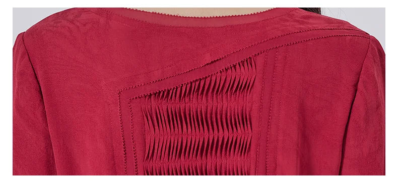 Close view of the back tucked panel, where directional pleats mirror the folds of a rose petal. From Borcelleclothes.