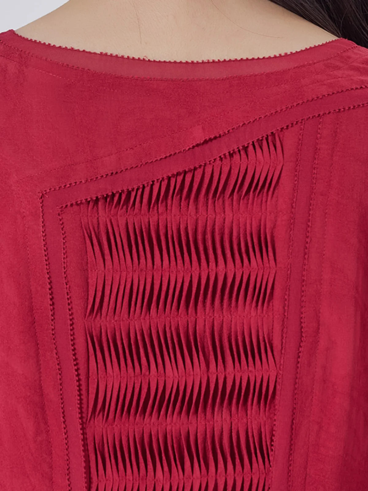 Detailed view of the back bodice with tucked panel and double layered overlays. From Borcelleclothes.