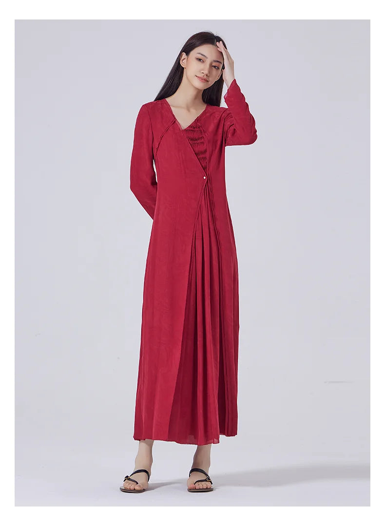 Model touching her hair, revealing the refined asymmetry of the neckline and shoulder detail. From Borcelleclothes.