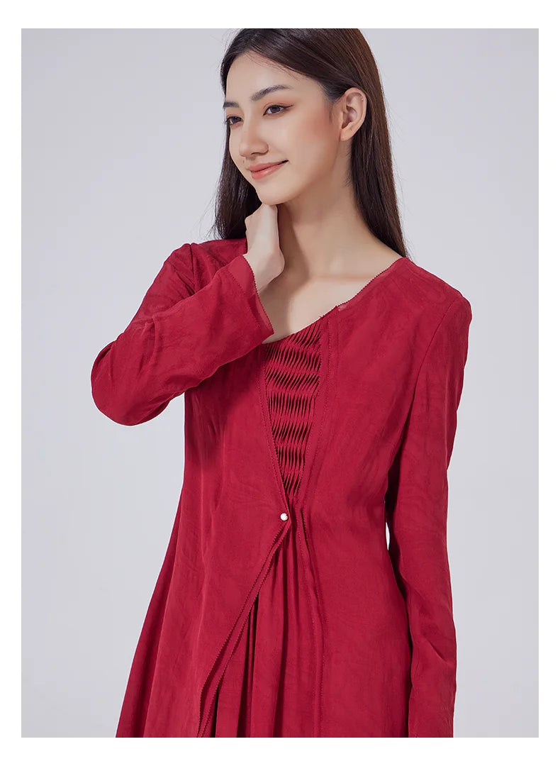 Model gently touching her neck, drawing attention to the sheer georgette emerging from the V-neckline. From Borcelleclothes.