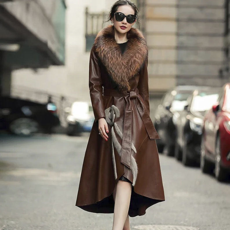 Women's goatskin down coat in Irish Coffee with a fox fur collar and mink fur appliqué. A sculptural high-low hem and flared design enhance its regal silhouette. Borcelleclothes.