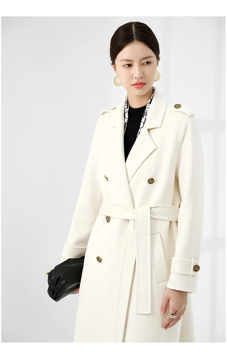 A model wearing the Women's Grade A Cashmere Coat in Floral White, gazing to the side, highlighting the coat’s refined sophistication and classic tailoring. From Borcelleclothes.