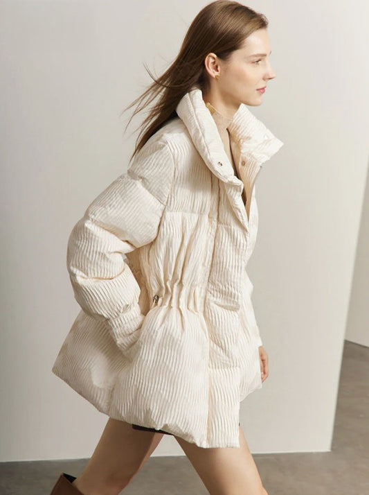 Model striding quickly in the Pearl Bush jacquard down jacket. From Borcelleclothes.