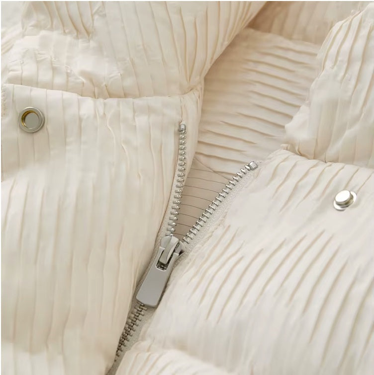 Upper zipper puller detail on the Pearl Bush jacquard down jacket. From Borcelleclothes.