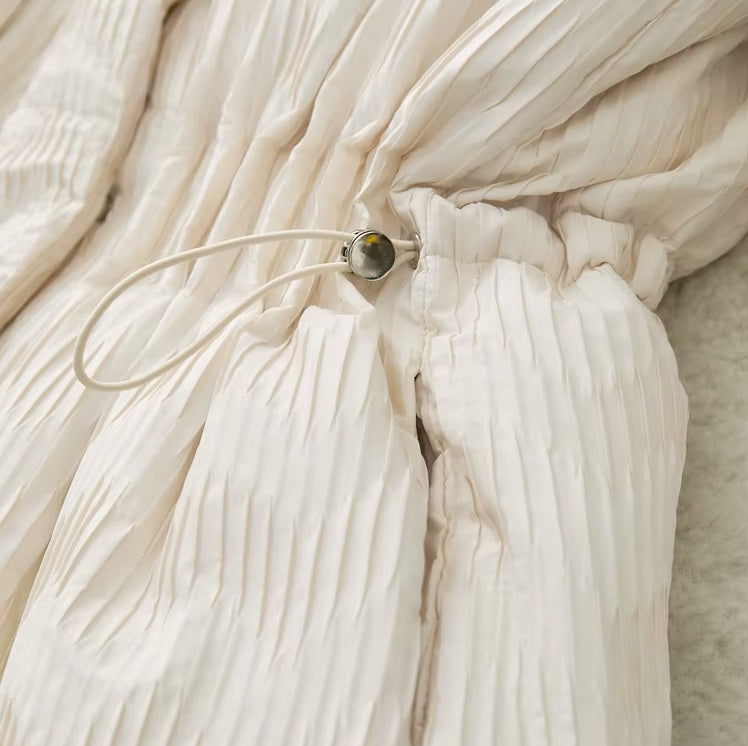 Waist cord adjuster on the Pearl Bush jacquard down jacket. From Borcelleclothes.