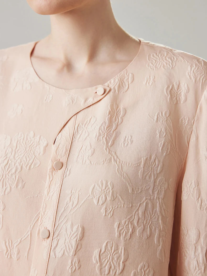 Model wearing jacquard silk blouse in Oyster Pink, upper part with round neckline. From Borcelleclothes.