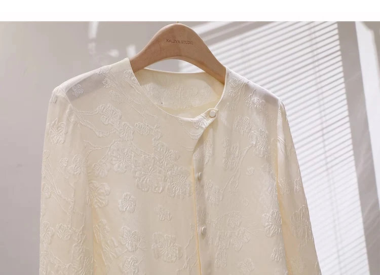 Pearl Bush jacquard silk blouse on hanger, upper front section with collar and curved placket. From Borcelleclothes.