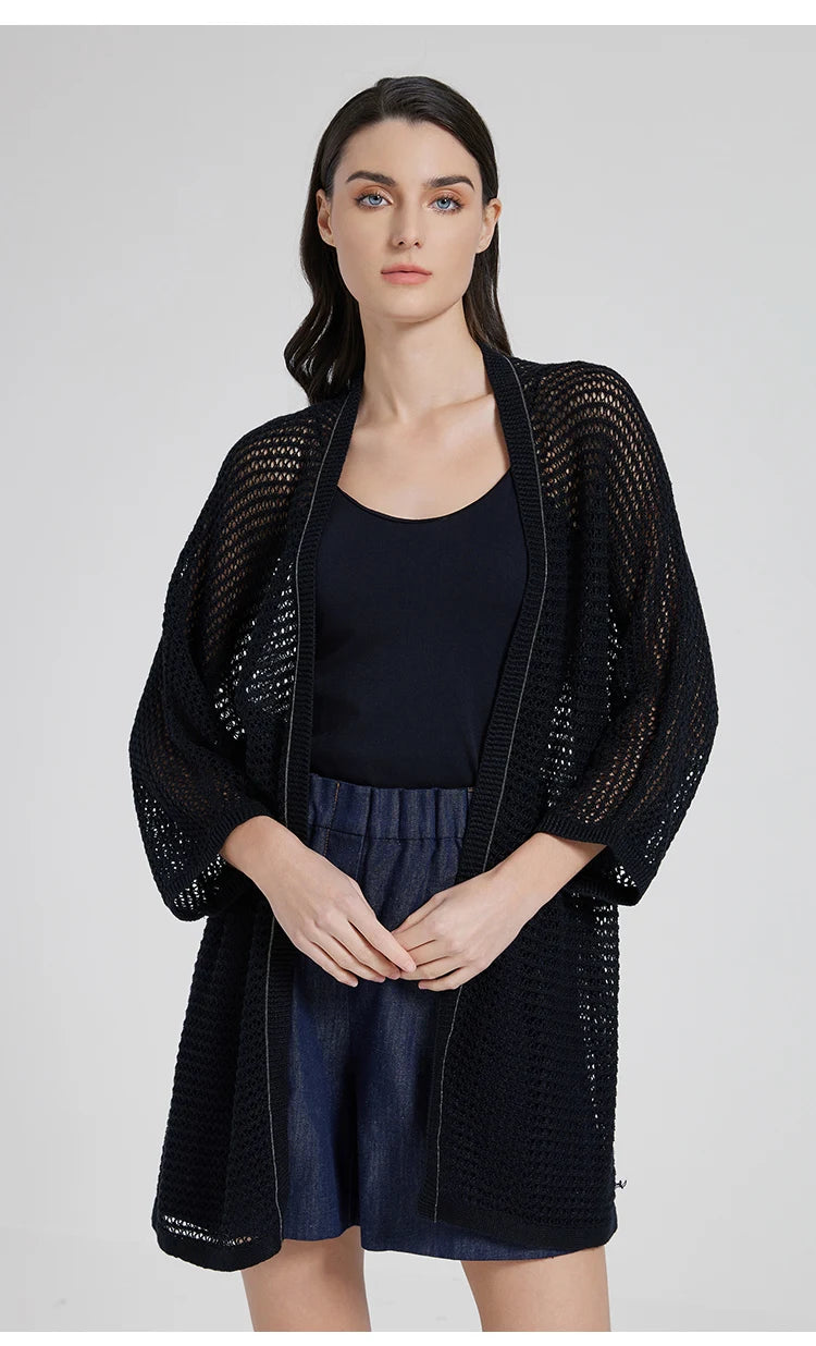 Model in Onyx lace overlay with fingertips lightly touching, evoking a sense of quiet intimacy. From Borcelleclothes.