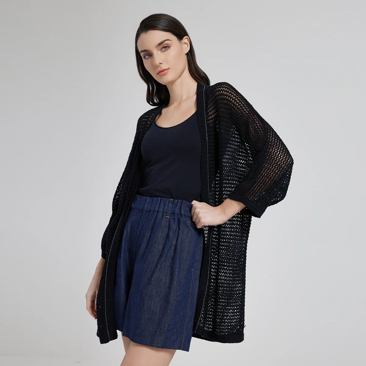Sheer kimono-style overlay in Onyx, featuring an airy net-like knit and delicate chain trim, designed to subtly reveal the silhouette beneath. From Borcelleclothes.
