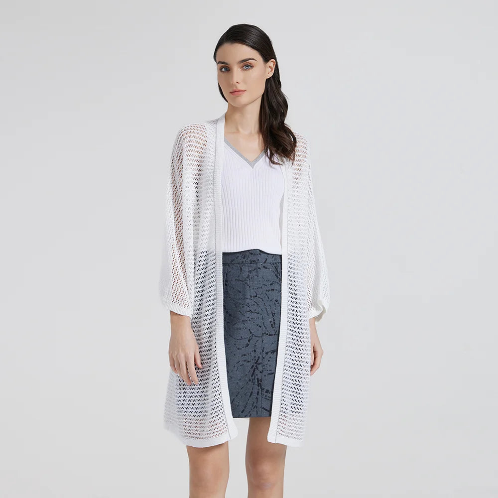 Model wearing the White Lilac kimono-style lace overlay, turned slightly with her head tilted to the side. From Borcelleclothes.