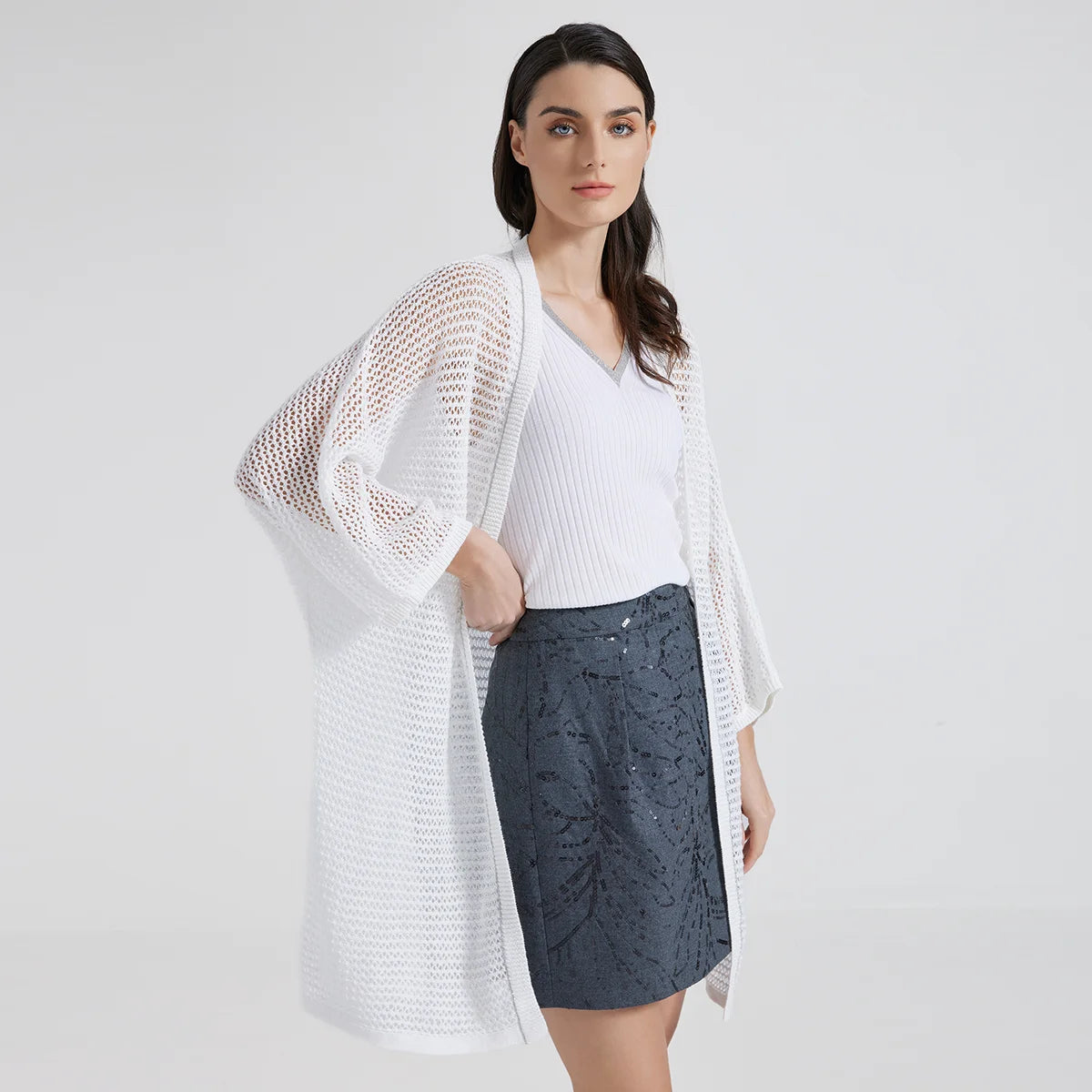 Sheer kimono-style overlay in White Lilac, featuring an airy net-like knit and delicate chain trim, designed to subtly reveal the silhouette beneath. From Borcelleclothes.