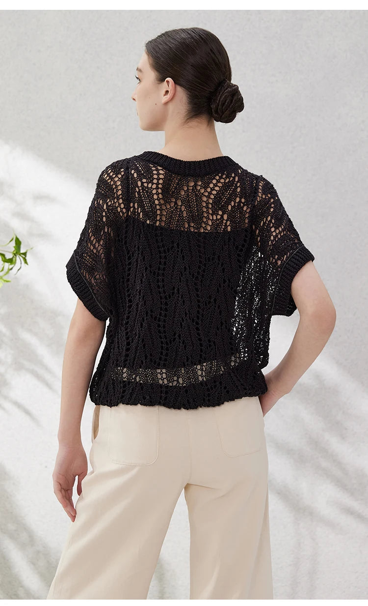 Back view of the black leaf-patterned lace top in linen, highlighting the openwork knit and sculptural shape. From Borcelleclothes.