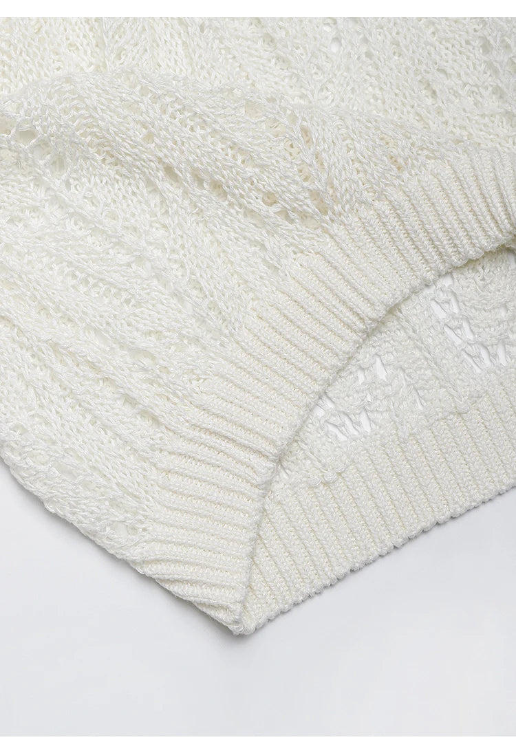 Close-up of the Whisper top’s bottom hem, finished with a ribbed band that contrasts the openness of the knit. From Borcelleclothes.