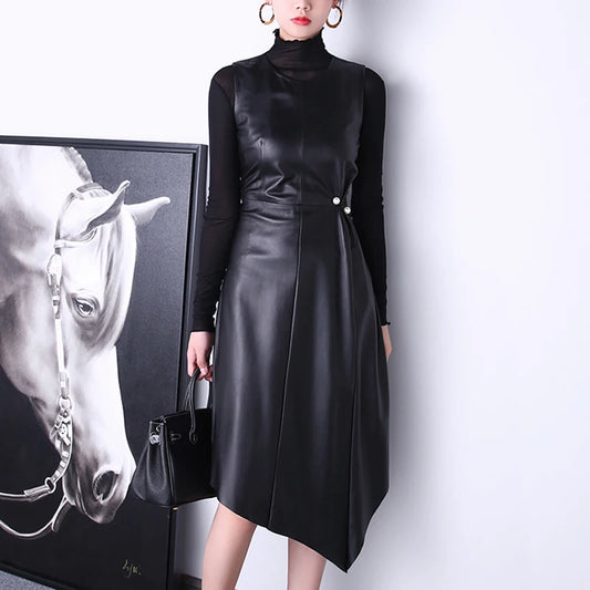 Women's Leather Asymmetrical Dress in Onyx features the refined A-line silhouette, ruched waist detail with statement buttons, and asymmetrical hem, balancing structure with modern elegance. Borcelleclothes.