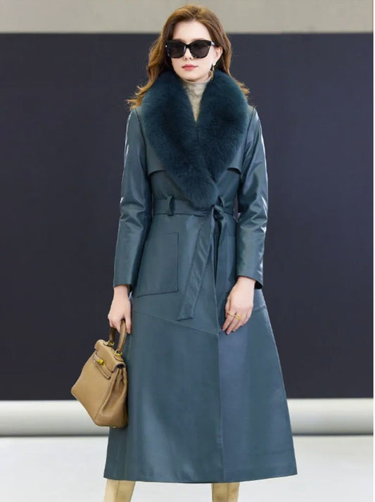 Women's Leather Coat of Prestige in Nile Blue. Model holds a structured handbag, highlighting the coat’s refined silhouette, luxurious sheepskin texture, and deep, enigmatic shade. Borcelleclothes.