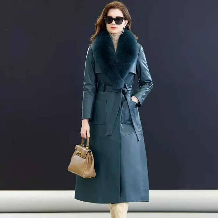 Women's Leather Coat of Prestige in Nile Blue. A mid-calf wrap coat crafted from sumptuous sheepskin, designed for effortless elegance and quiet confidence. Featuring a structured yet fluid silhouette, notch lapels, a detachable fox fur collar, and refined patch pockets. A statement of poise and authority. Borcelleclothes.