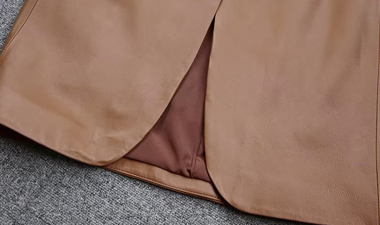 Women's Leather Midi Dress in French Beige. Close-up of the rounded front slit, designed for graceful movement and subtle allure. Borcelleclothes.