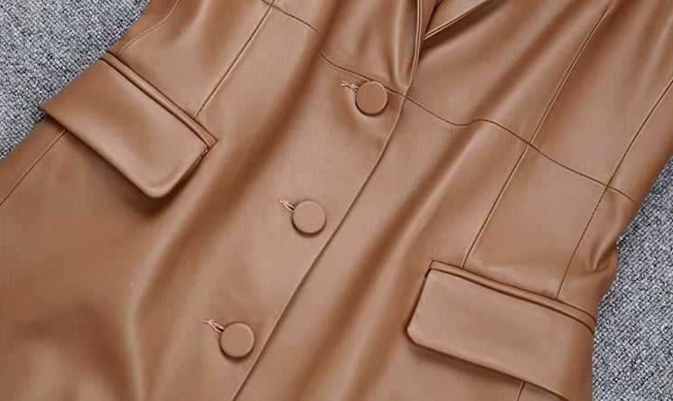 Women's Leather Midi Dress in French Beige. Midsection close-up featuring the front flap pockets and tailored waistline. Borcelleclothes.