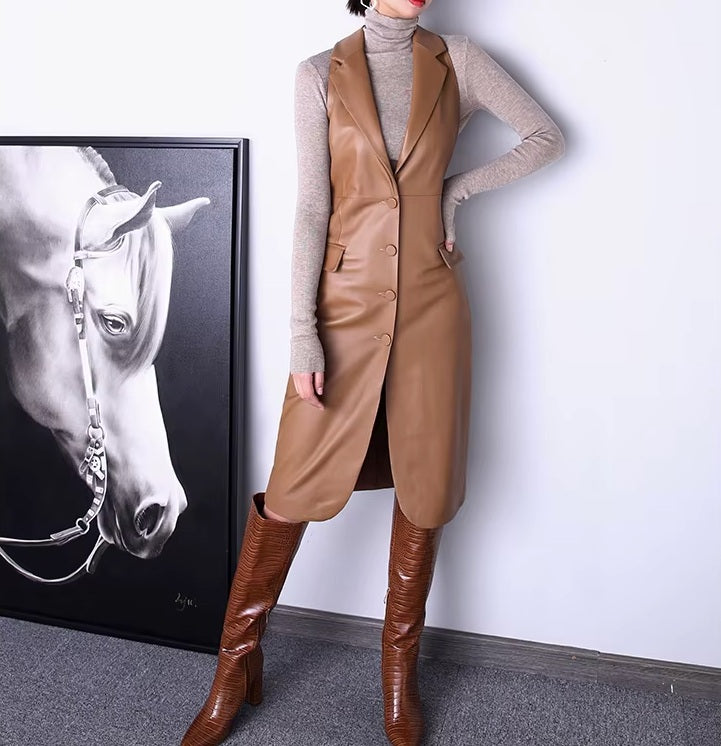 Women's Leather Midi Dress in French Beige. Model places a hand on her hip, highlighting the structured silhouette and tailored waistline. Borcelleclothes.