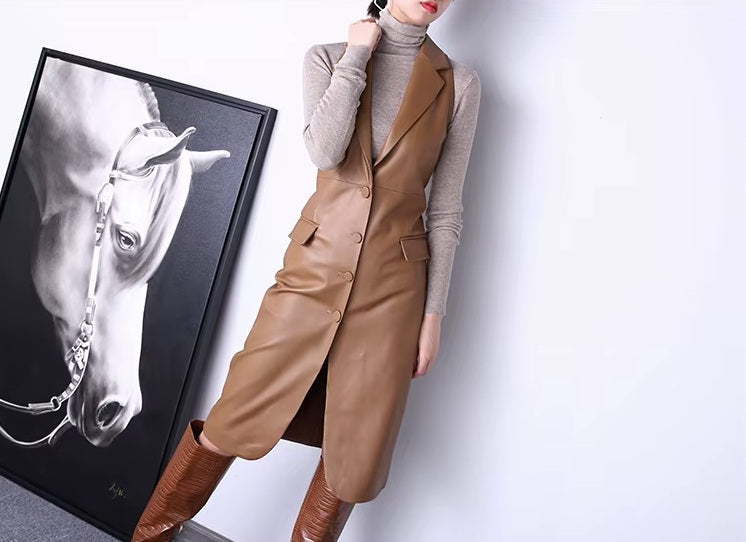 Women's Leather Midi Dress in French Beige. Model gently touches the lapel, emphasizing the dress’s refined structure. Borcelleclothes.
