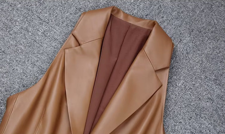 Women's Leather Midi Dress in French Beige. Close-up of the deep V-neckline, structured lapels, and leather-covered buttons. Borcelleclothes.