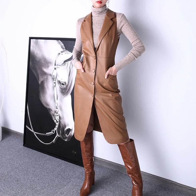 Women's Leather Midi Dress in French Beige, featuring the dress’s deep V-neckline, structured lapels, and rounded front slit, highlighting its balance of sophistication and allure. Borcelleclothes.