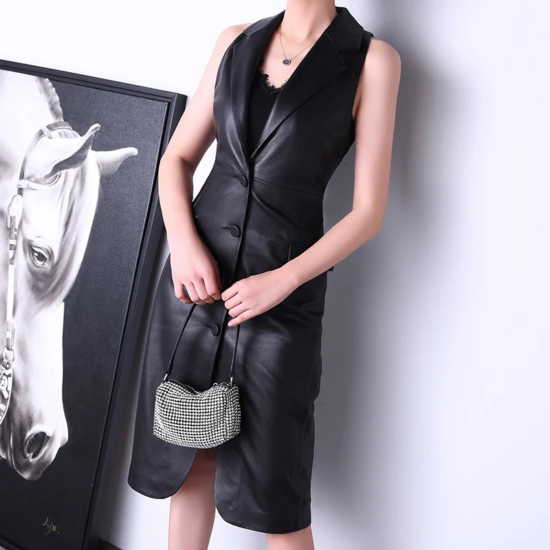 Women's Leather Midi Dress in Onyx, featuring the dress’s deep V-neckline, structured lapels, and rounded front slit, highlighting its balance of sophistication and allure. Borcelleclothes.