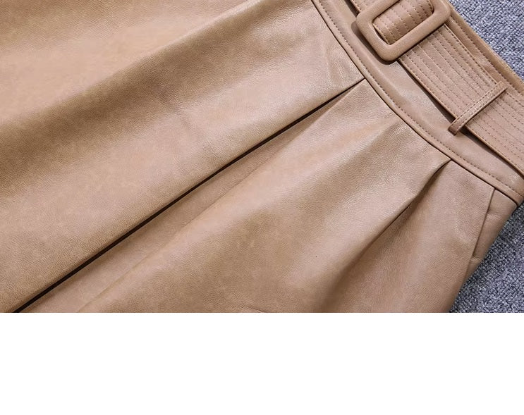 Women's Leather Midi Skirt in French Beige. Close-up of the deep center box pleat, creating a structured yet fluid movement. Borcelleclothes.