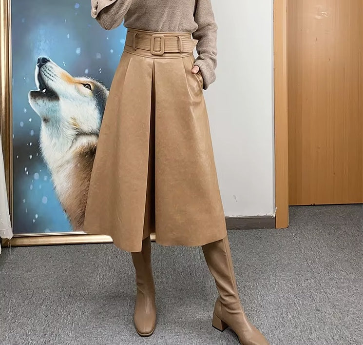Women's Leather Midi Skirt in French Beige. Model rests a hand in the pocket, emphasizing the balance between structure and functionality. Borcelleclothes.