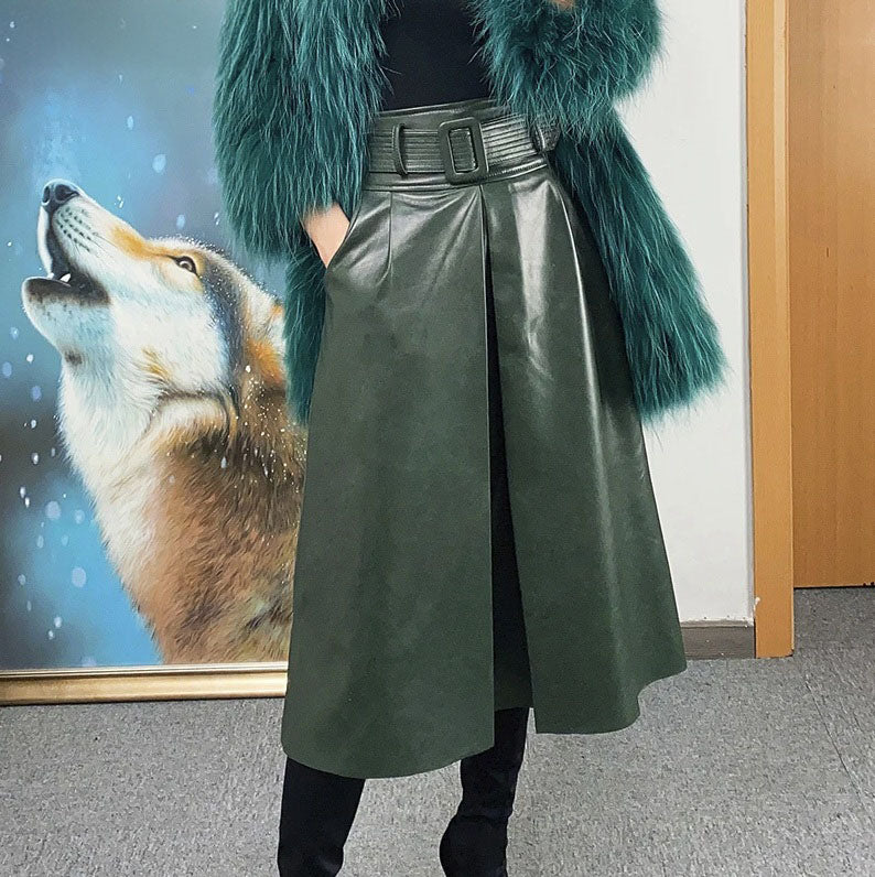 Women's Leather Midi Skirt in Lunar Green. Model places a hand in the seamlessly integrated side pocket, showcasing the skirt’s tailored design and sculpted elegance. Borcelleclothes.
