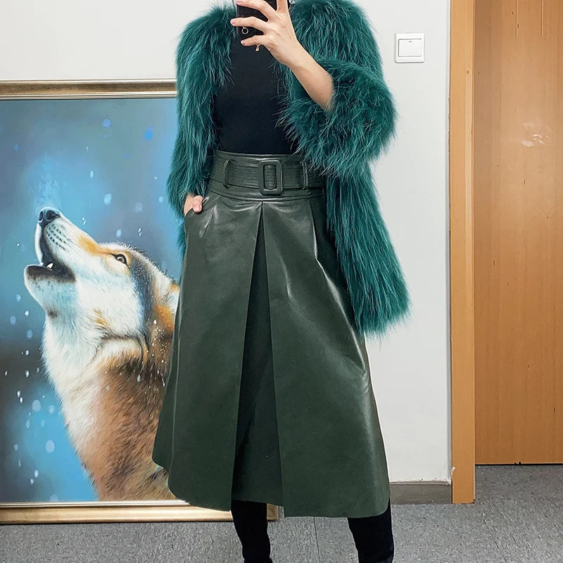 Women's Leather Midi Skirt in Lunar Green. Model casually checks her phone, showcasing the modern versatility of the structured silhouette. Borcelleclothes.