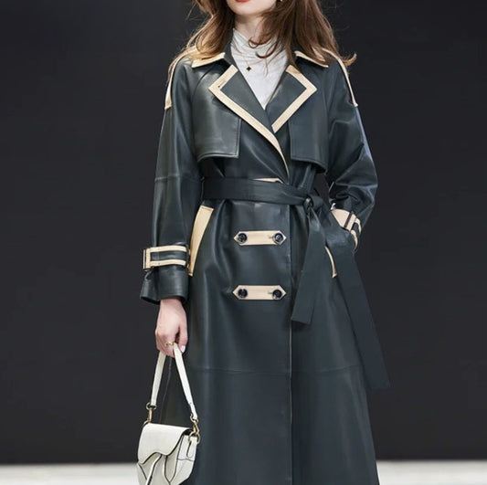 Women's Leather Outer Space Trench. Model carries a structured handbag, emphasizing the coat’s commanding presence and refined contrast detailing. Borcelleclothes.